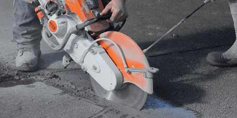 Diamond asphalt blade mounted on a walk-behind concrete saw for road surface cutting.