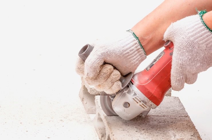 Concrete cutting blade creating expansion joints in freshly poured concrete pavement.